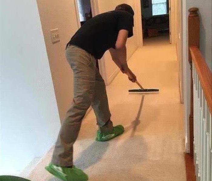 SERVPRO team member in action cleaning carpets.