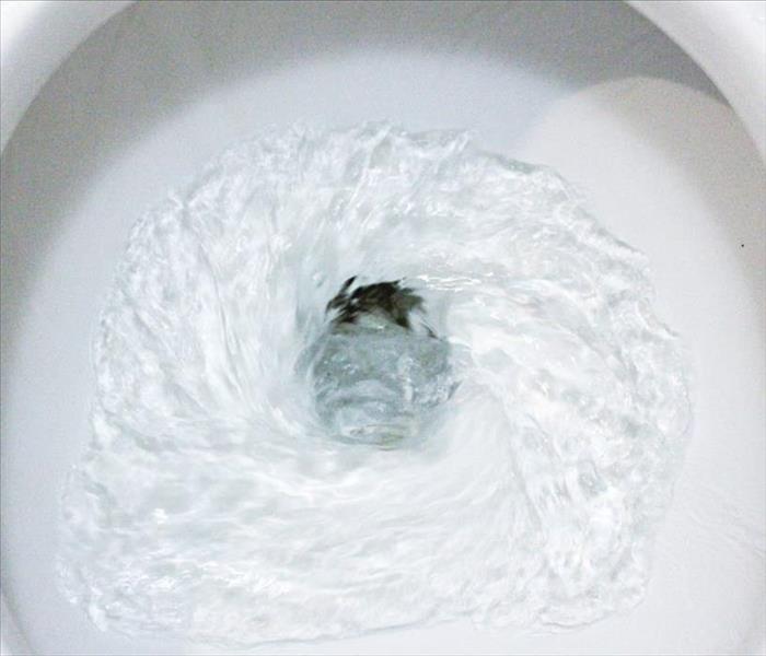 Water in toilet bowl flushing